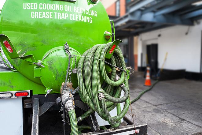 heavy-duty vacuum truck pumping out a grease trap in Bruce